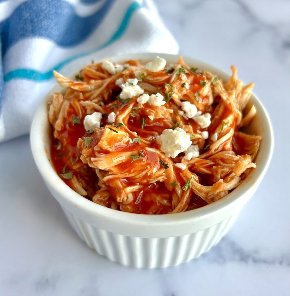 Shredded chicken with buffalo sauce and blue cheese crumbles
